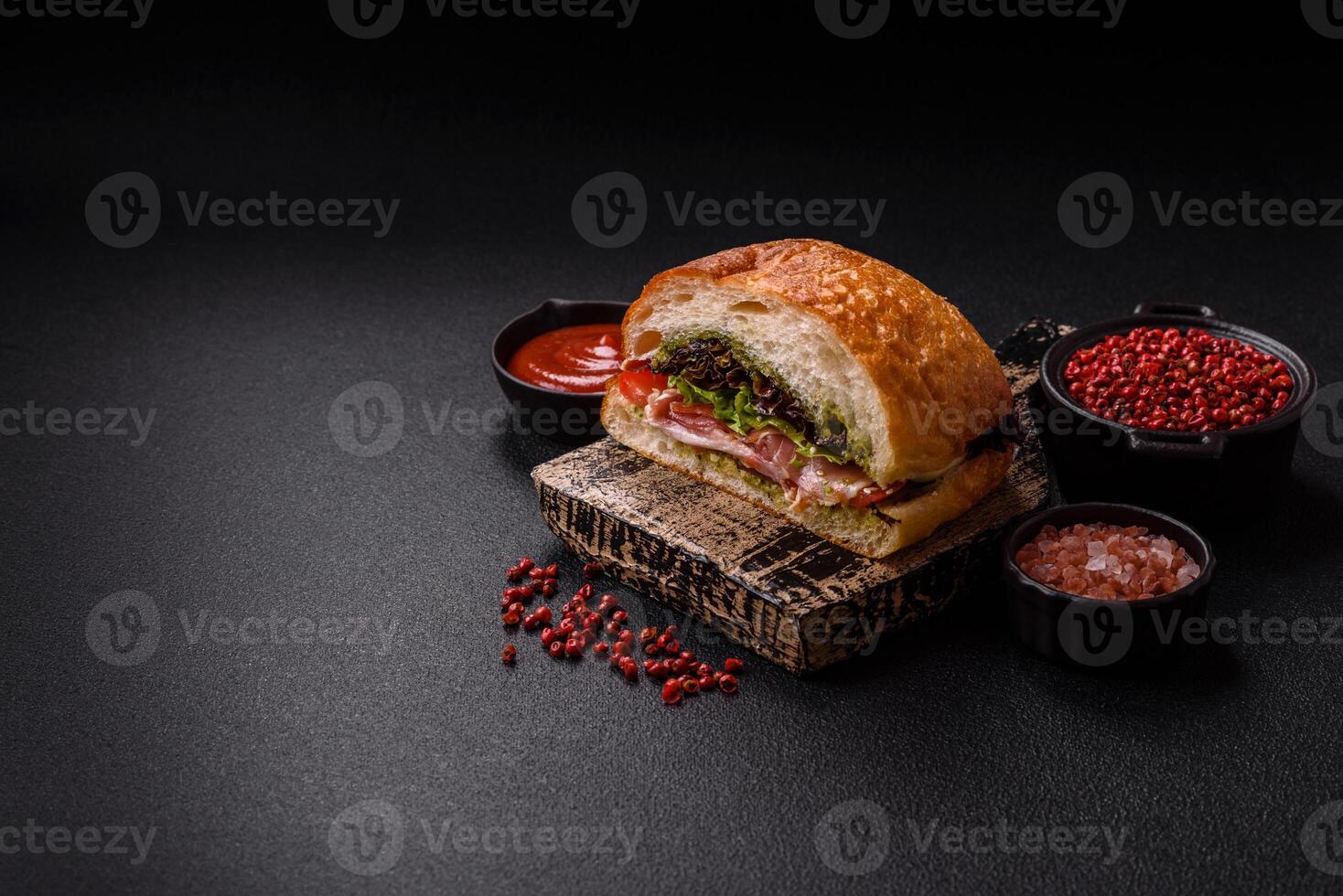Ciabata with jamon or prosciutto, tomatoes, cheese and lettuce photo