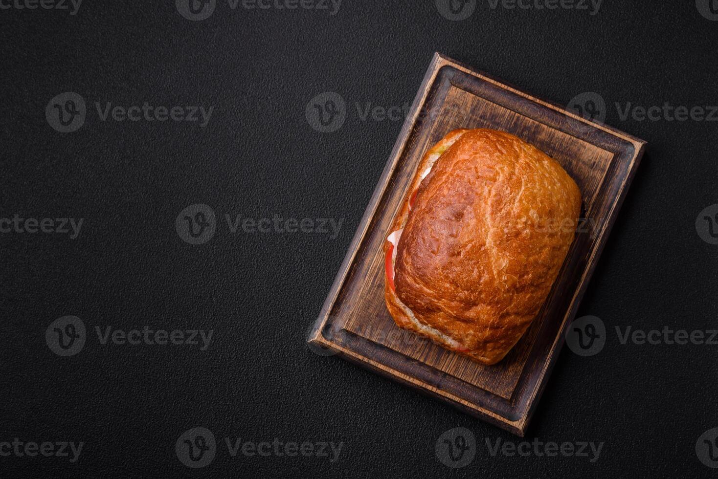 Ciabata with jamon or prosciutto, tomatoes, cheese and lettuce photo
