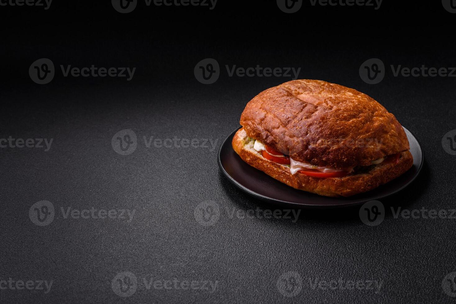 Ciabata with jamon or prosciutto, tomatoes, cheese and lettuce photo
