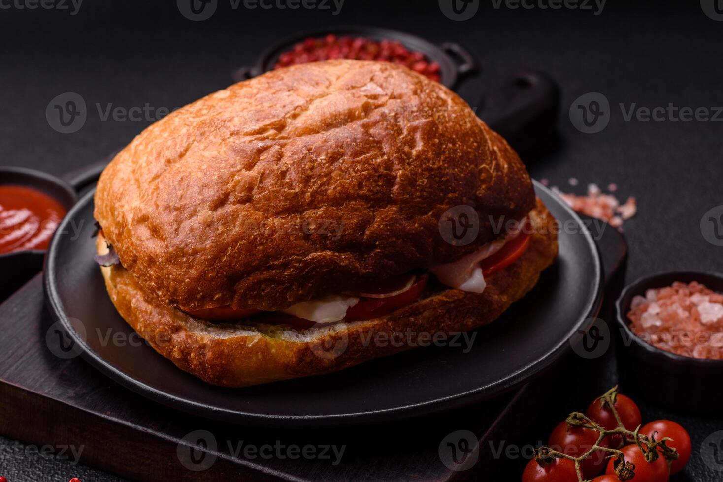Ciabata with jamon or prosciutto, tomatoes, cheese and lettuce photo