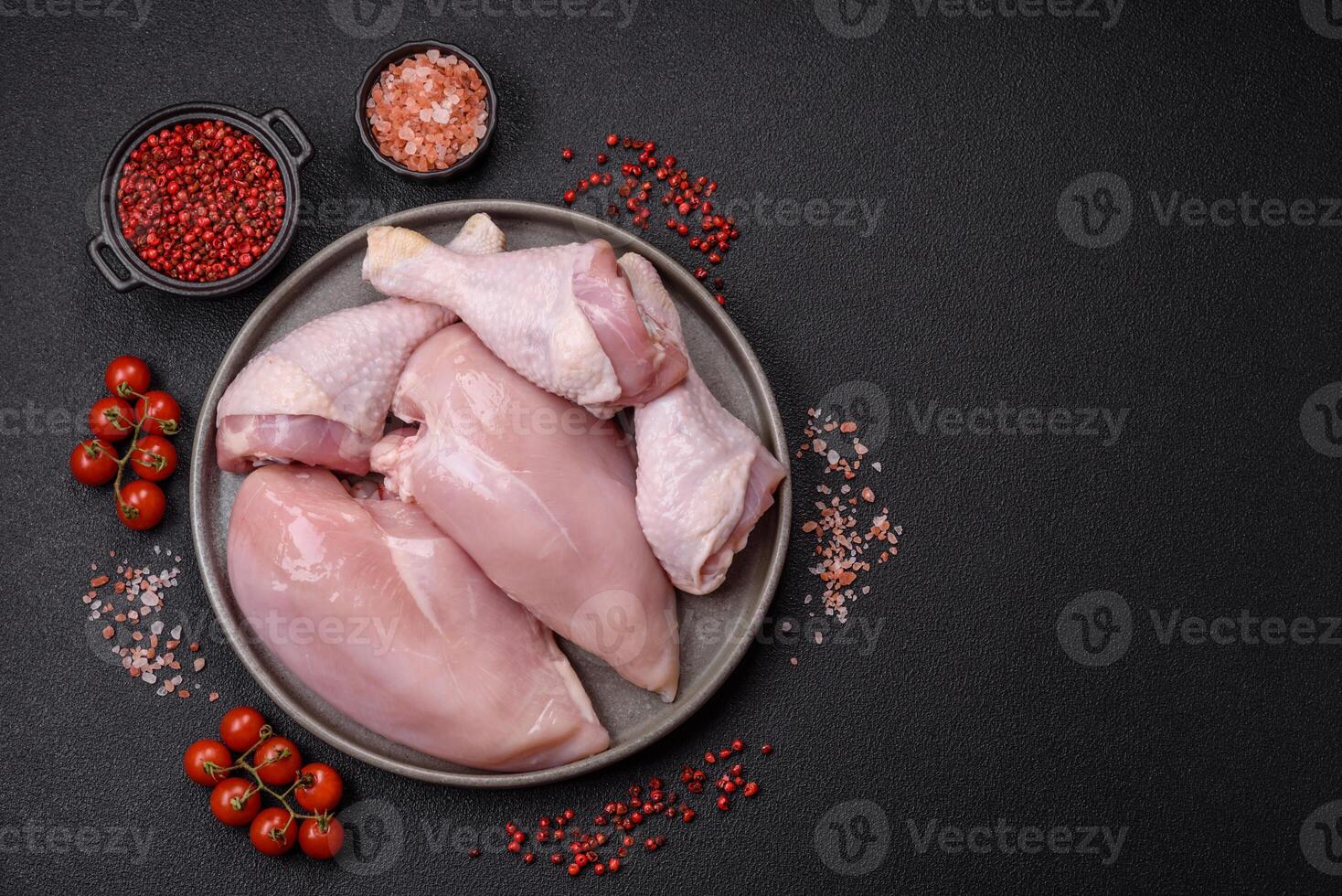 Pieces of raw chicken or turkey fillet with salt, spices and herbs photo