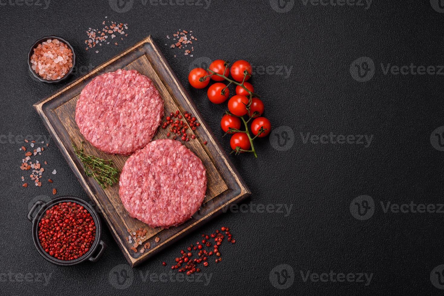 Fresh raw ground beef burger patty with salt and spices photo