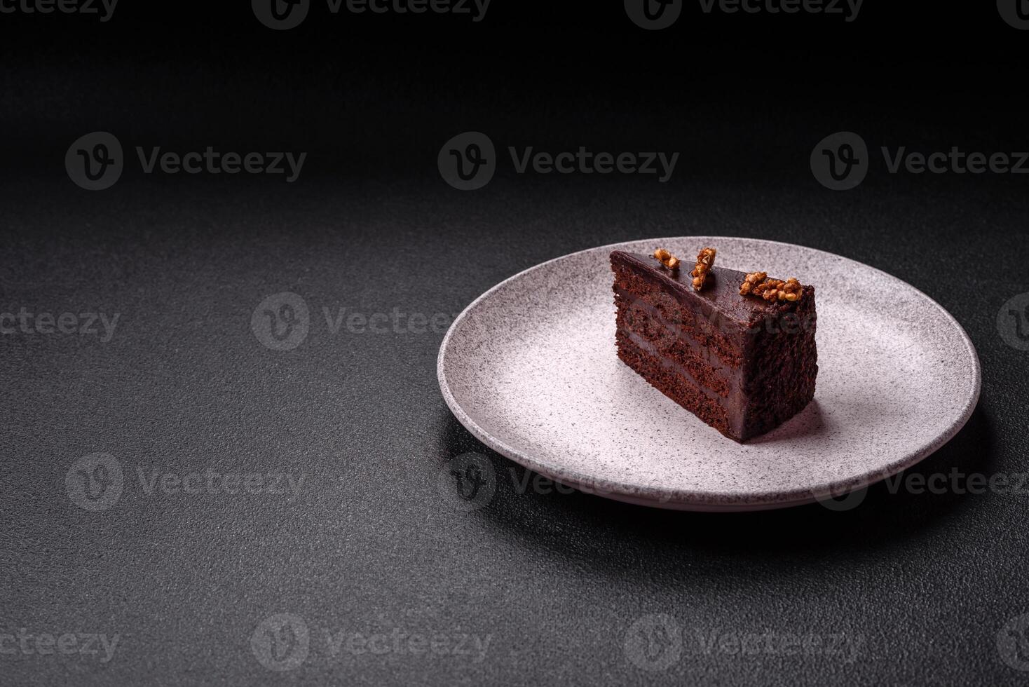 Piece of sweet chocolate cake with nuts photo