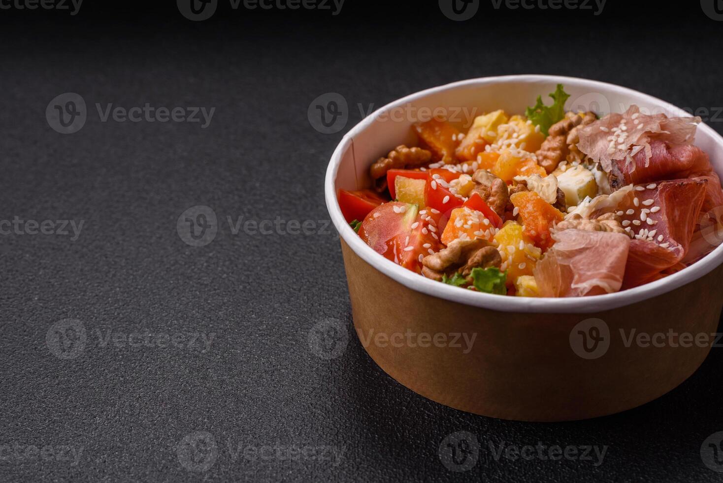Appetizing salad with prosciutto, pumpkin, cheese and tomatoes photo