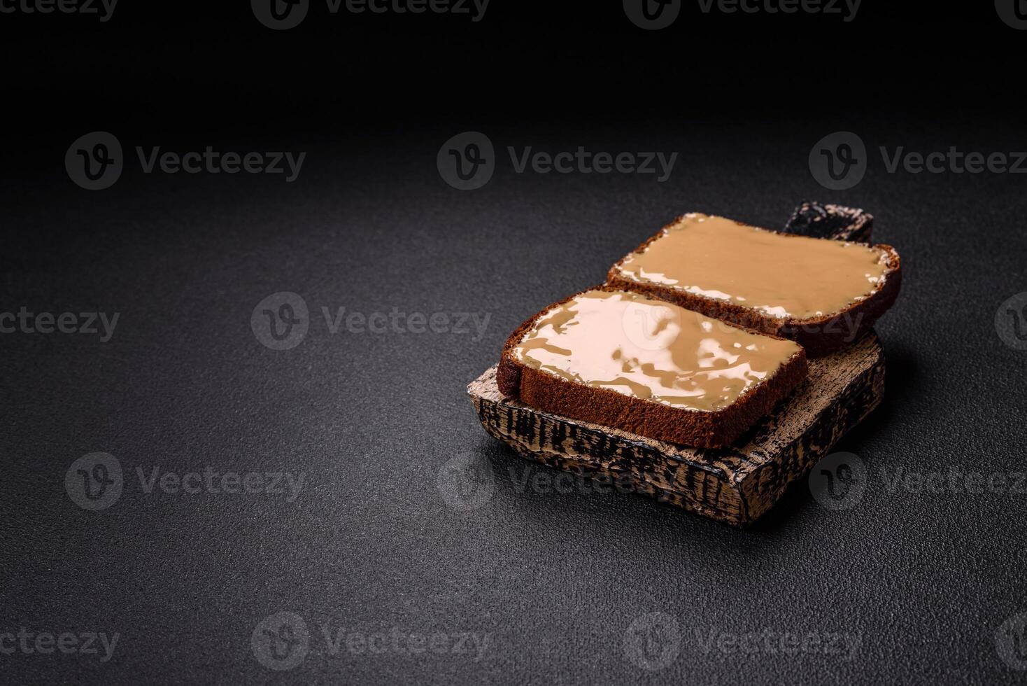 Sandwiches with toast bread, peanut butter and raspberry or strawberry jam photo