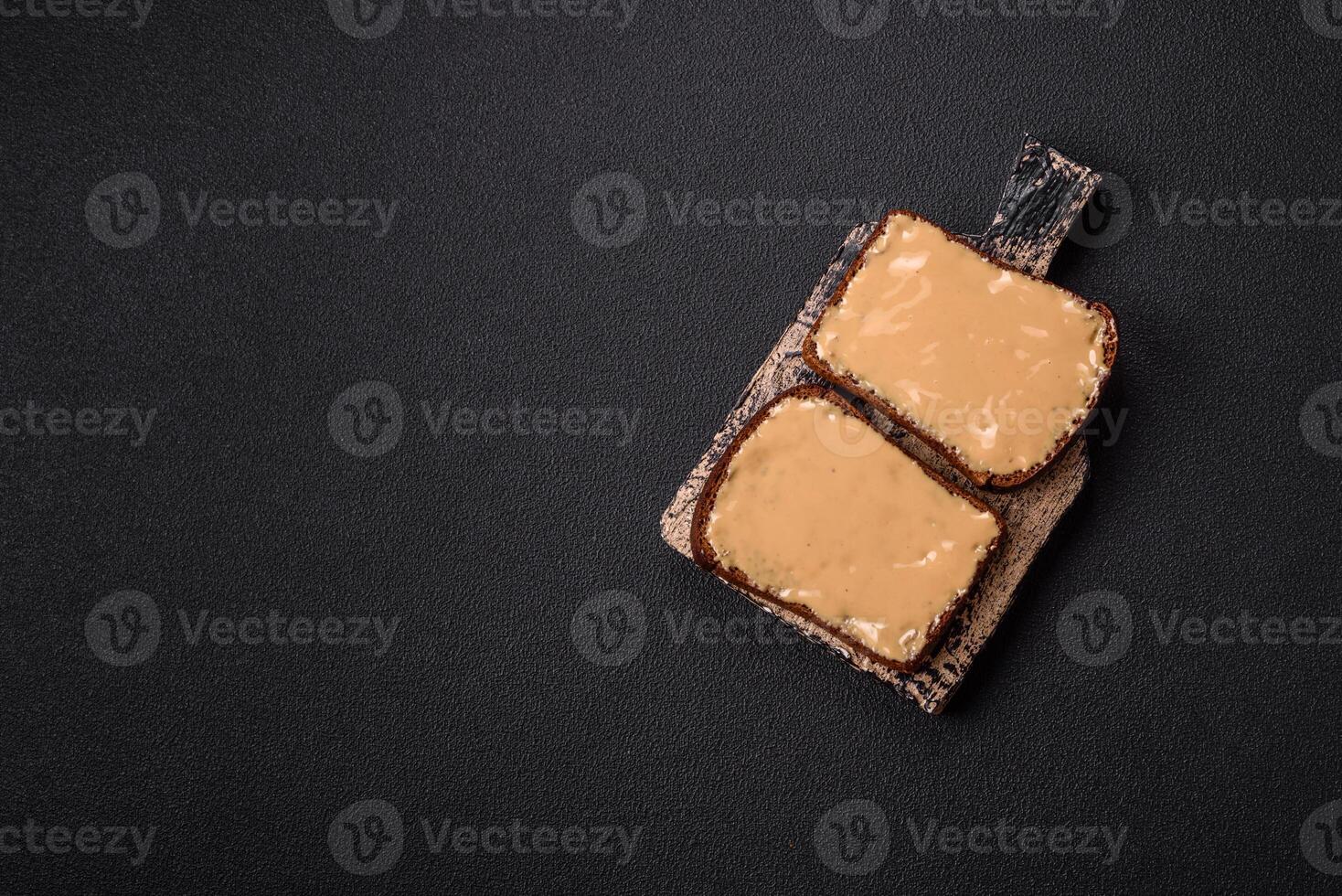 Sandwiches with toast bread, peanut butter and raspberry or strawberry jam photo