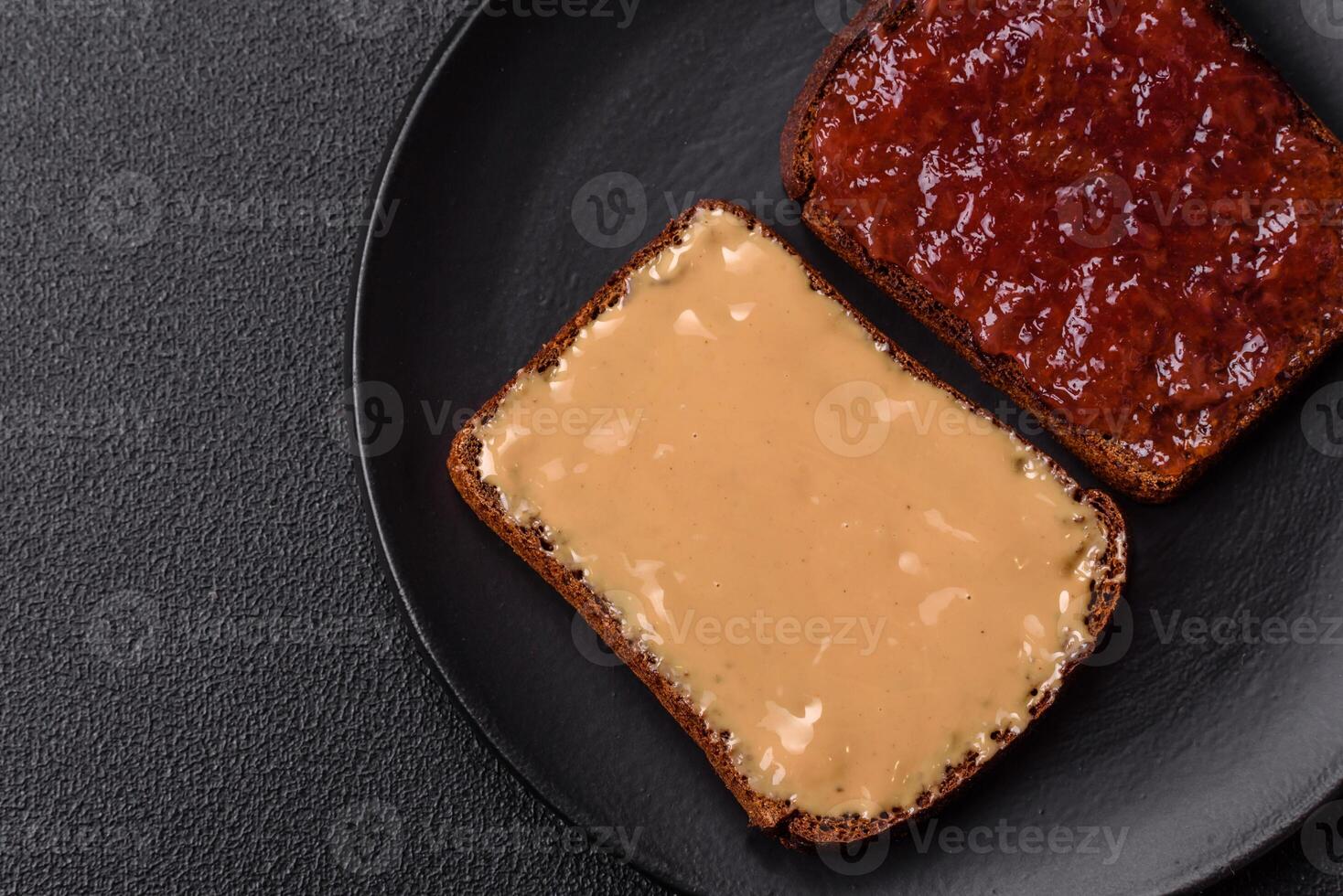 Sandwiches with toast bread, peanut butter and raspberry or strawberry jam photo