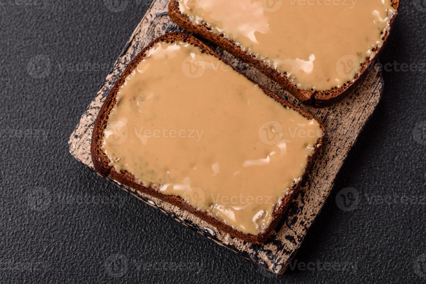 Sandwiches with toast bread, peanut butter and raspberry or strawberry jam photo