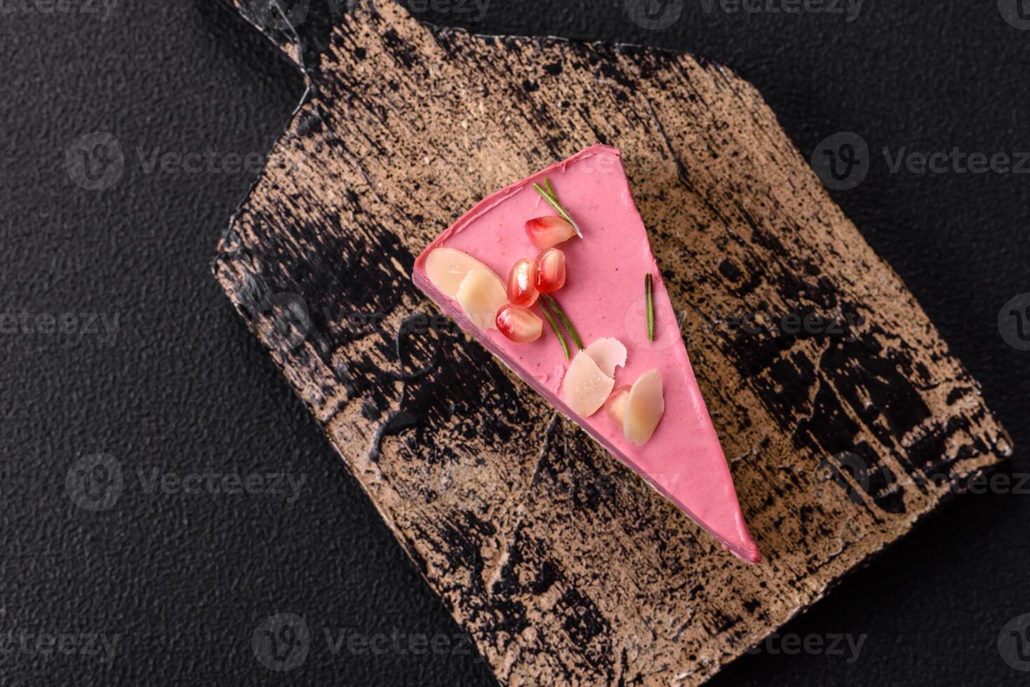 Piece of sweet cheesecake with pink cream cheese of raspberry or strawberry flavor photo