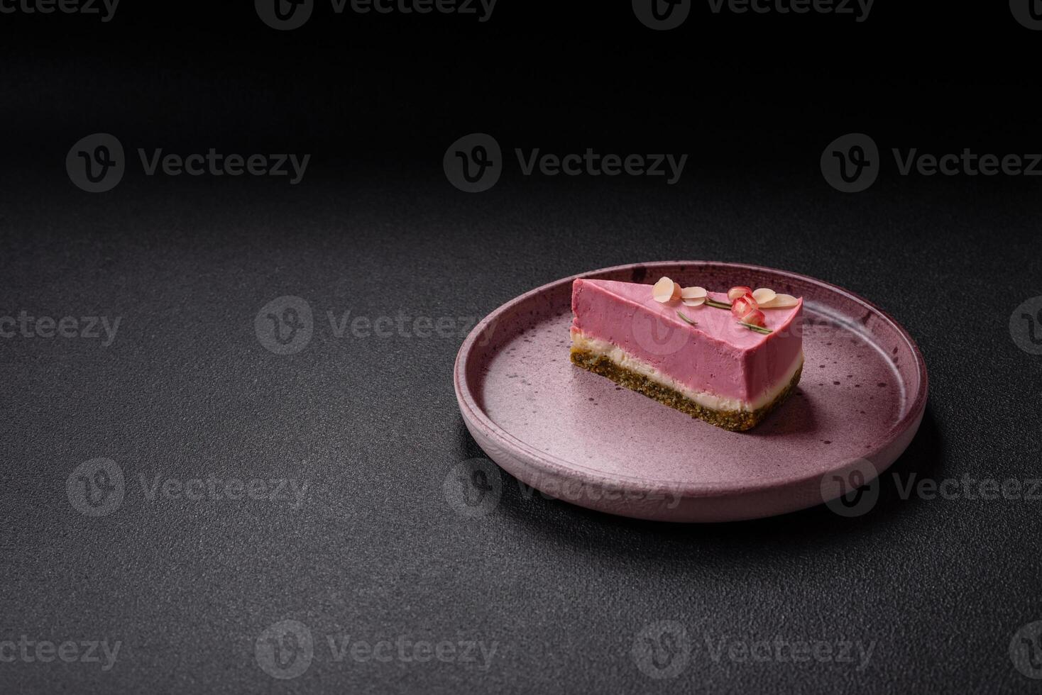 Piece of sweet cheesecake with pink cream cheese of raspberry or strawberry flavor photo