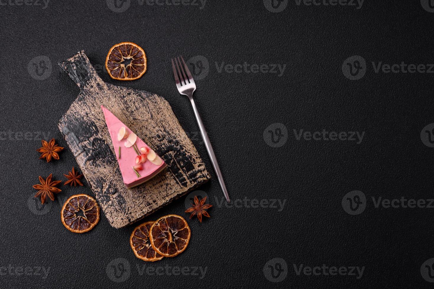 Piece of sweet cheesecake with pink cream cheese of raspberry or strawberry flavor photo