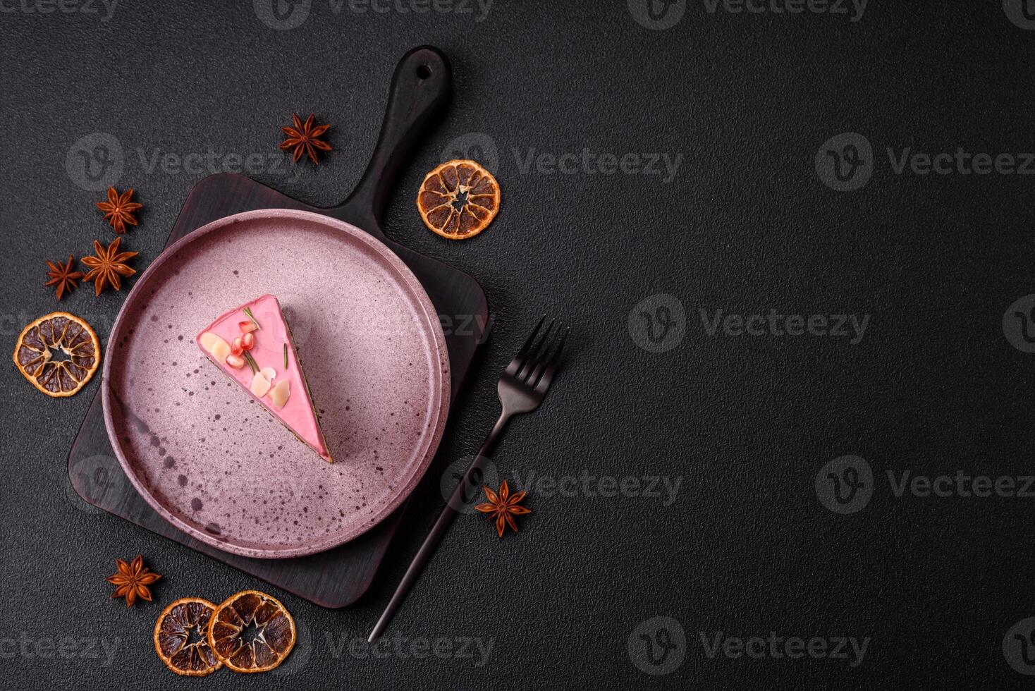 Piece of sweet cheesecake with pink cream cheese of raspberry or strawberry flavor photo