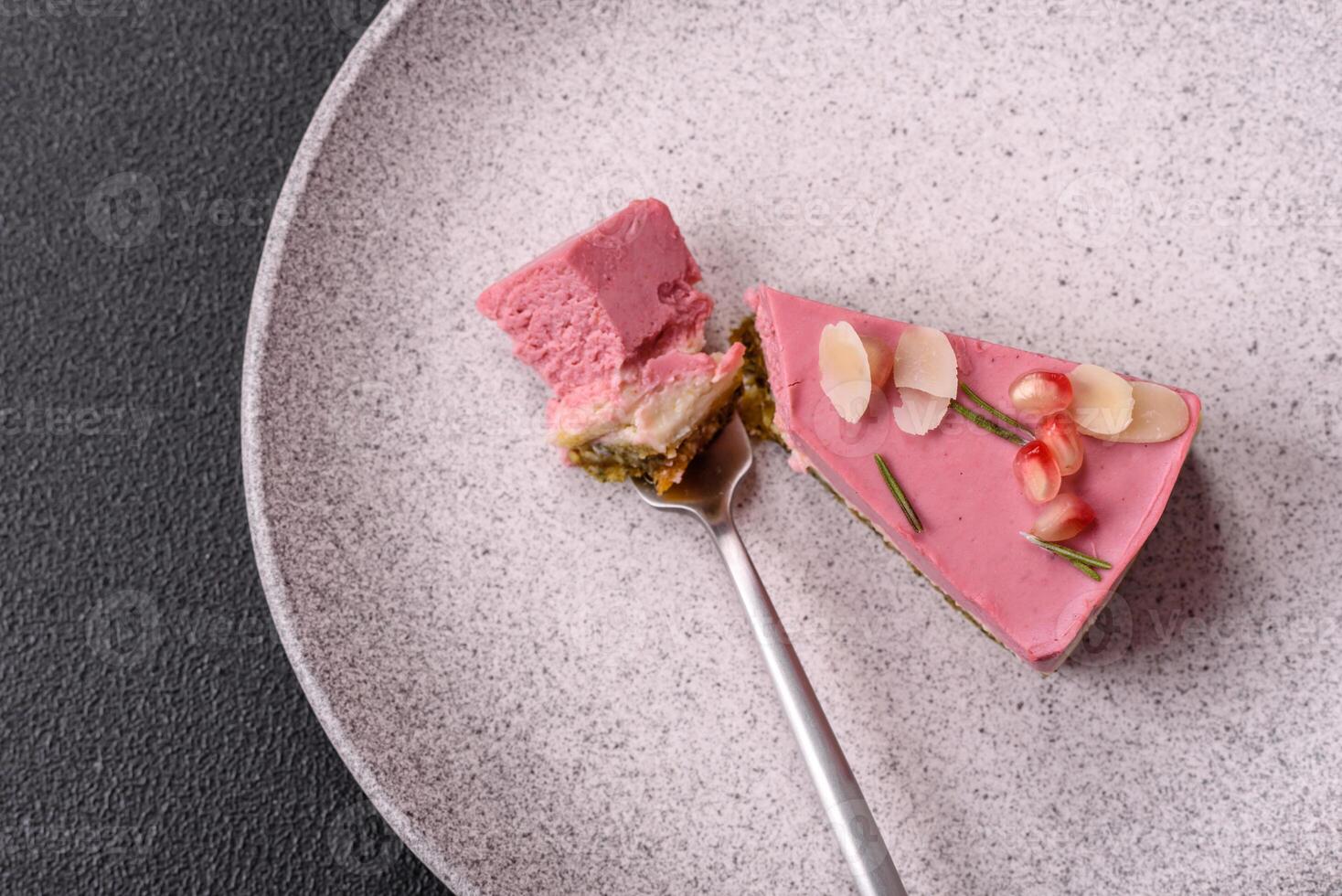 Piece of sweet cheesecake with pink cream cheese of raspberry or strawberry flavor photo