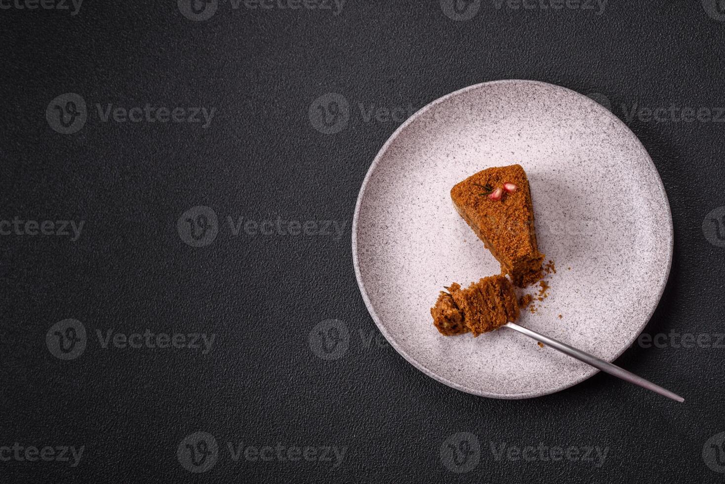 Piece of sweet layered honey cake photo