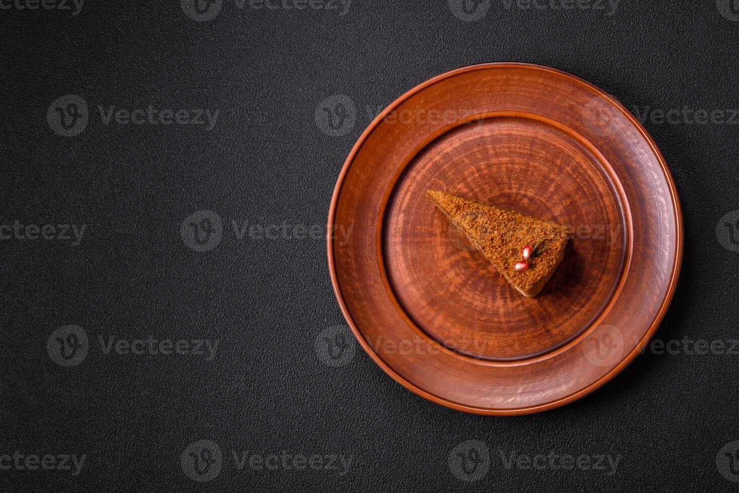 Piece of sweet layered honey cake photo