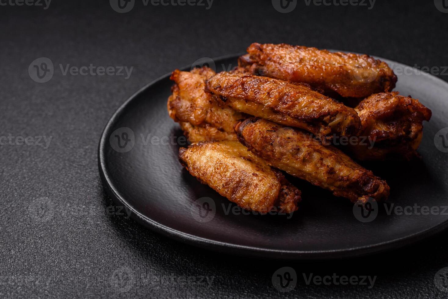 Grilled chicken wings with salt, spices and herbs photo