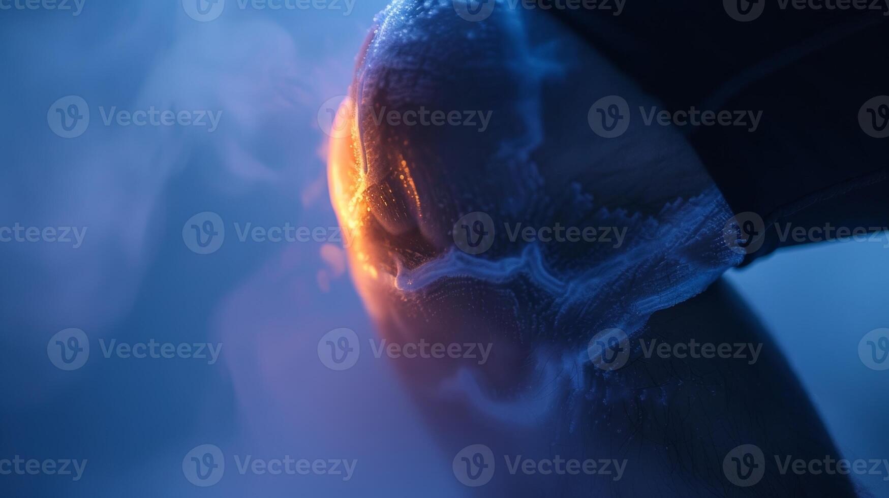 A closeup of a persons knee during cryotherapy showing the cold temperature trating deep into the joint tissue photo
