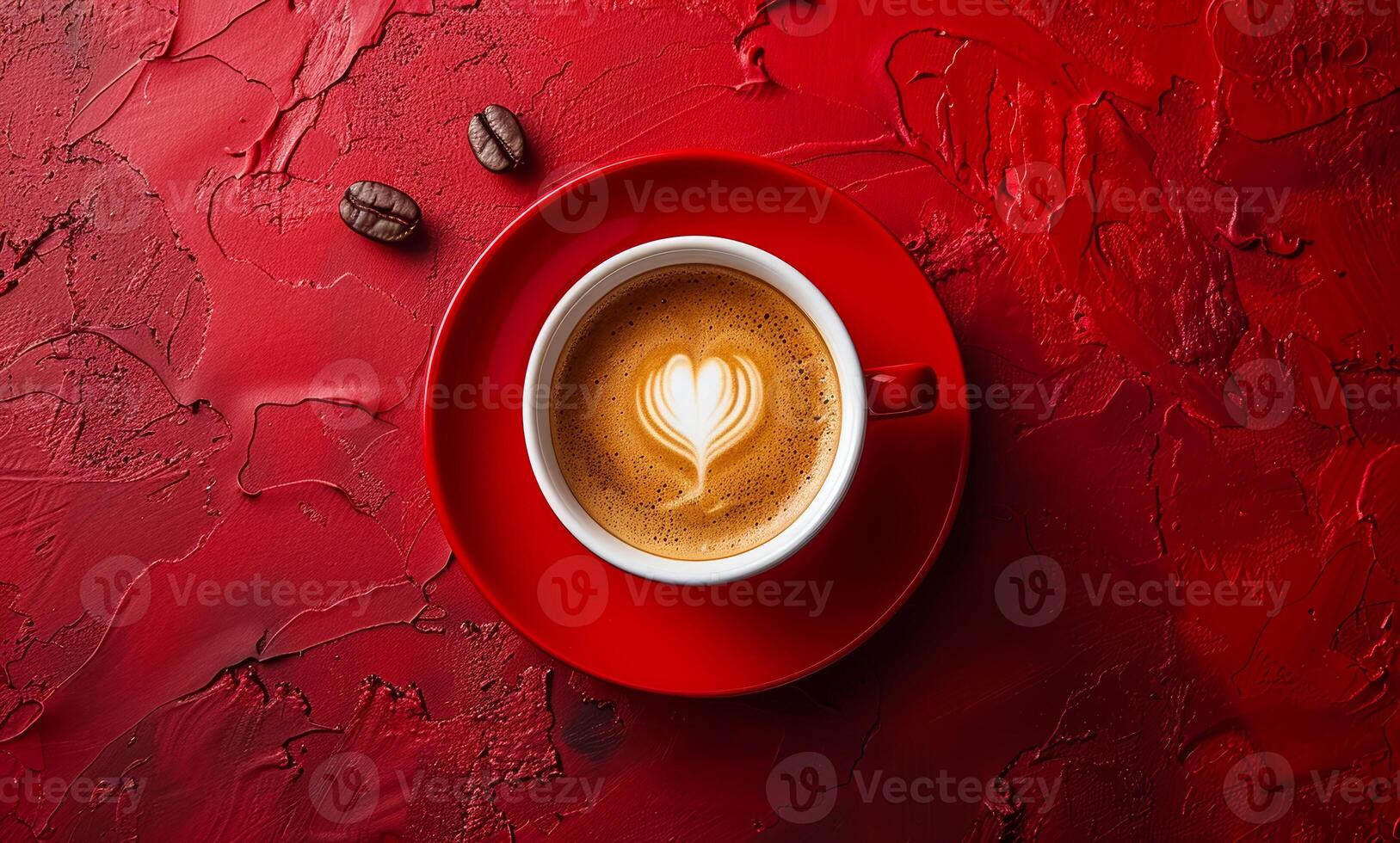 A red coffee cup with a heart design on it sits on a red background. The cup is filled with coffee and has a few coffee beans on top. Concept of warmth and comfort, as the coffee cup. photo