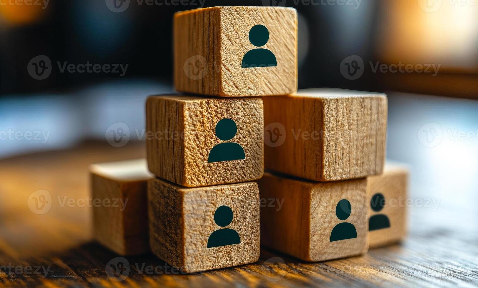 A stack of wooden blocks with people on them. The blocks are arranged in a pyramid shape. Concept of teamwork and collaboration, as the people on the blocks are working together to build something. photo