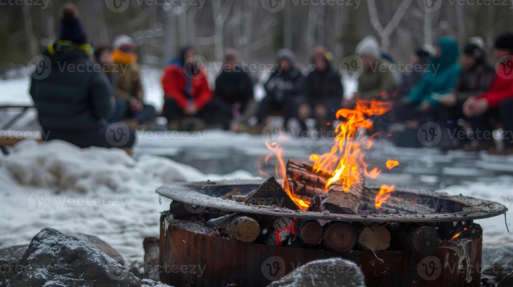 A group of people gathering around a fire pit sharing stories after a day of cold water immersion photo