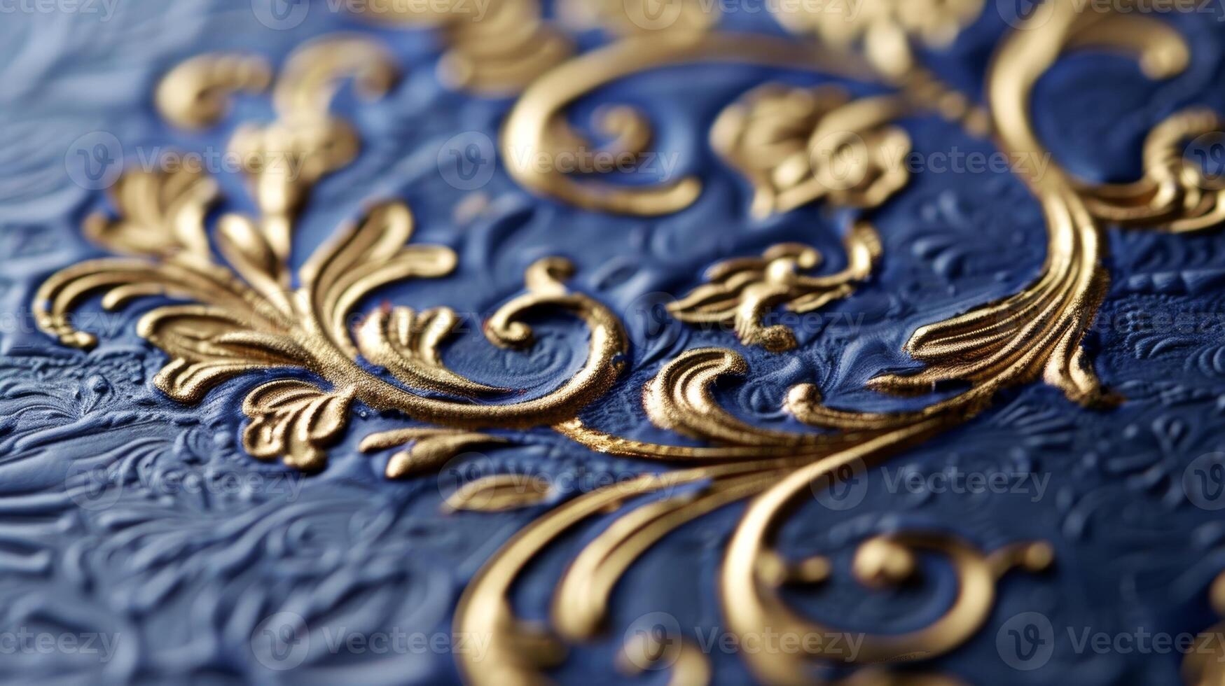An image of a goldfoil embossed monogram on a navy blue notecard. The monogram is intricately detailed with swirling vines and flourishes giving the stationery a luxurious feel photo