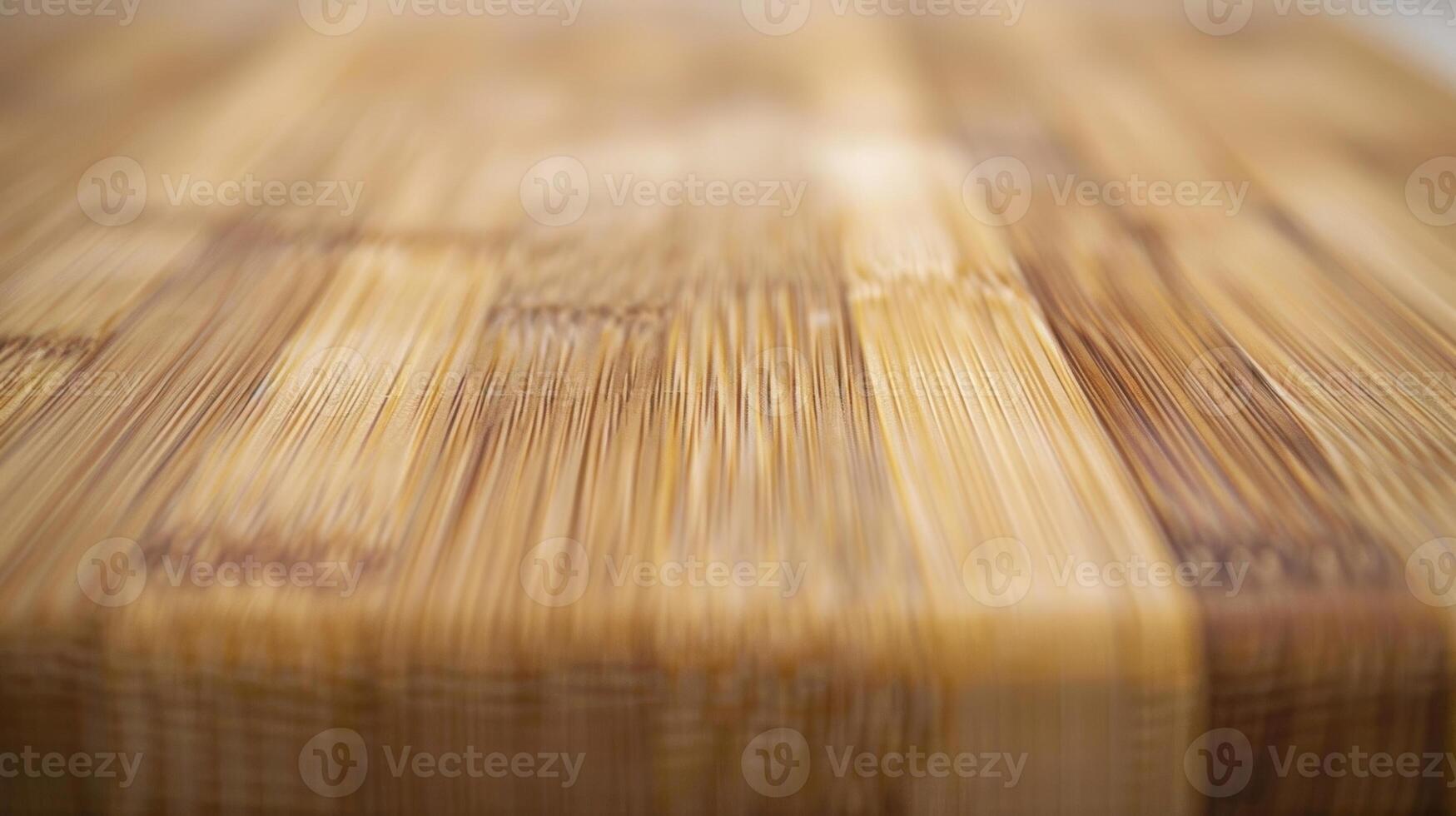 A closeup of a bamboo ting board highlighting the smooth and even surface of the wood. The intricate patterns of the grain add visual interest to the board photo