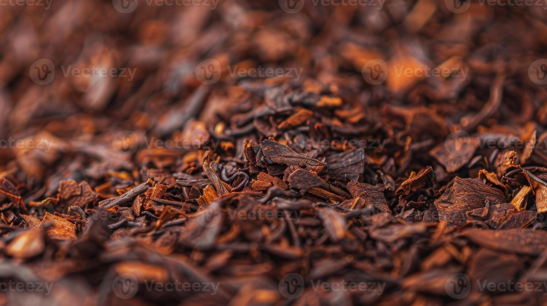 The wrinkled dark brown leaves of rooibos tea revealing the natural ridges and folds that imbue it with flavor photo