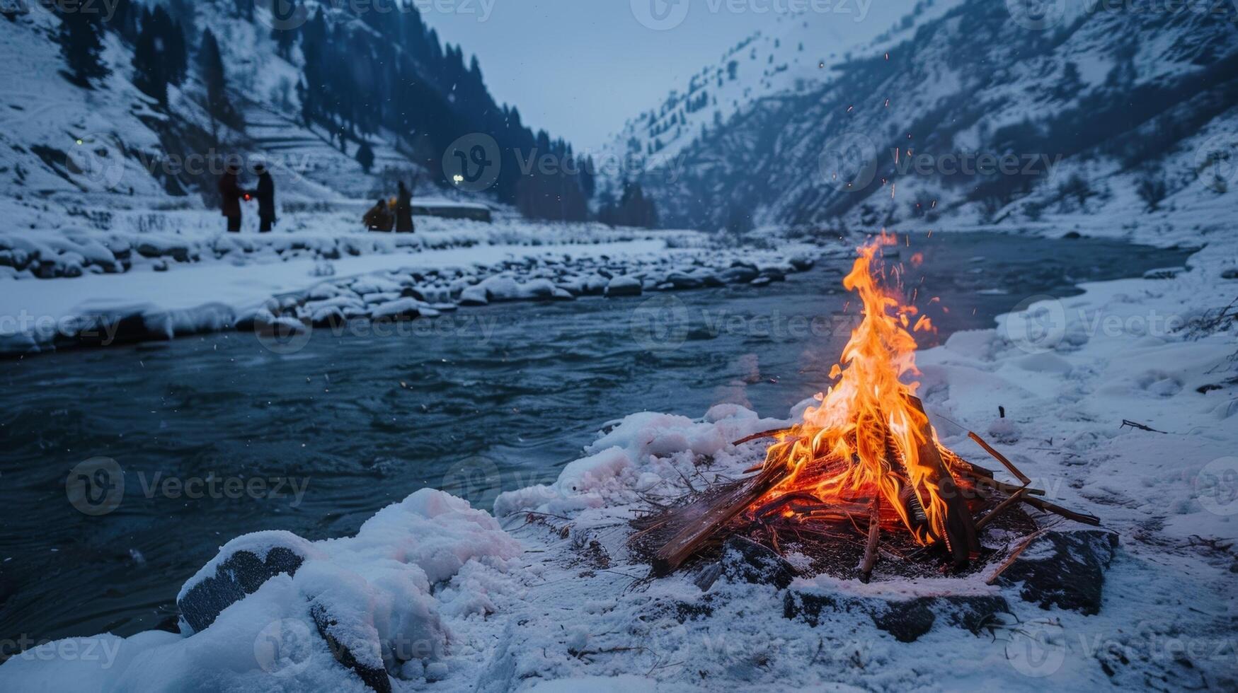 A sacred fire burning brightly in the midst of snowy mountains with people participating in a spiritual ceremony that involves taking ice baths in a nearby river photo