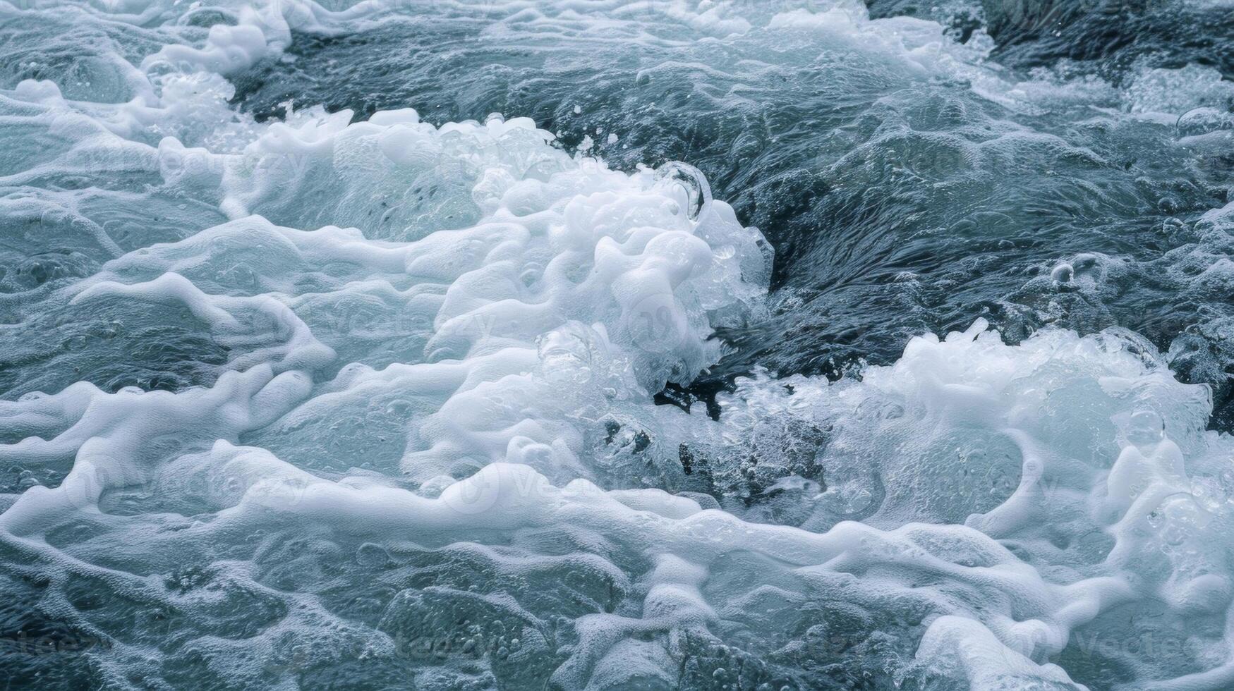 Trying to steady yourself against the current as the icy water rushes around you forming small white rapids photo