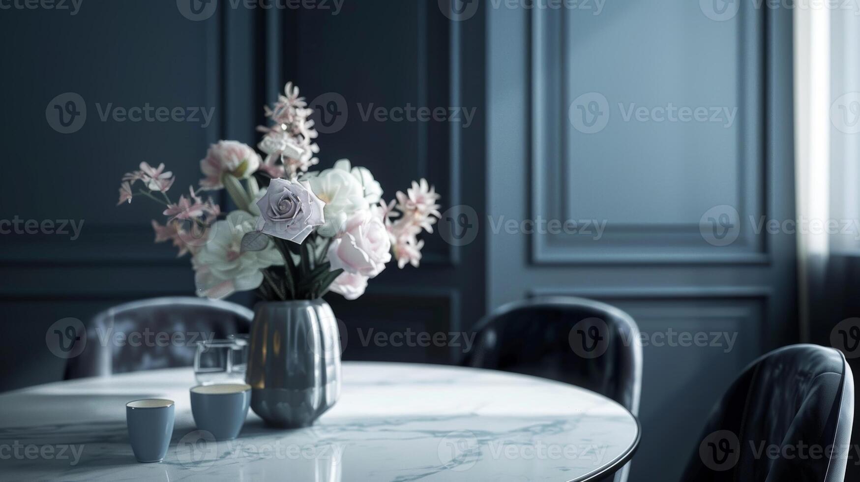 A minimalist dining room with muted navy walls a sleek marble dining table and velvet charcoal chairs accented with a muted blush bouquet centerpiece photo