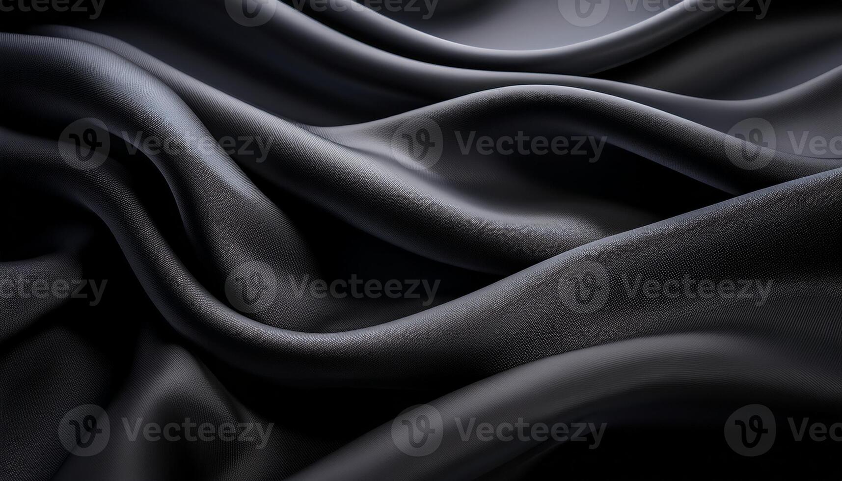 Elegant close-up of smooth black fabric draped in flowing folds, highlighting its soft texture and luxurious appearance. photo