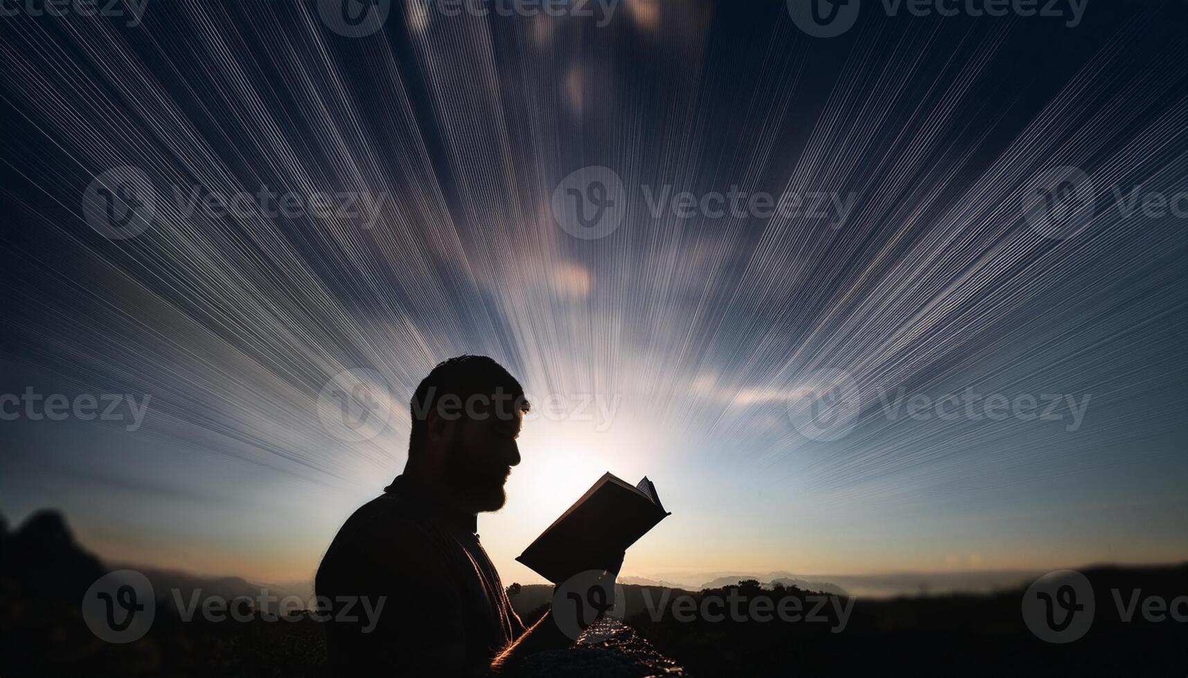 A man reading a book outdoors at sunrise, with dramatic light rays emanating from the background, symbolizing knowledge and inspiration. photo