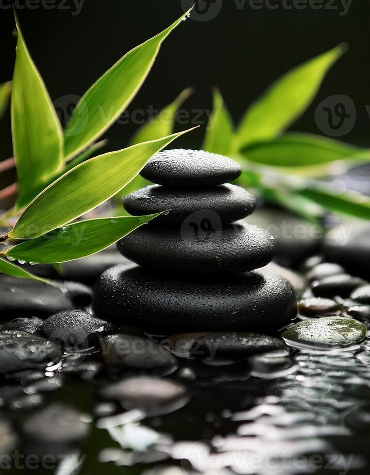 Stacked black spa stones with bamboo leaves surrounded by water, creating a serene and calming zen-like atmosphere for relaxation. photo