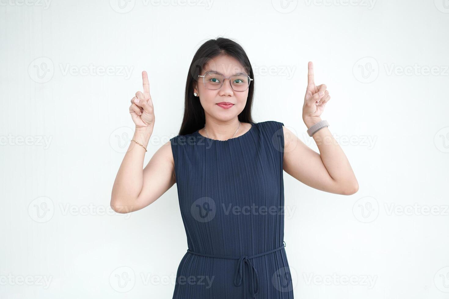 Beautiful Asian Woman wearing formal dress Showing Product and Pointing Up Isolated On White Background photo