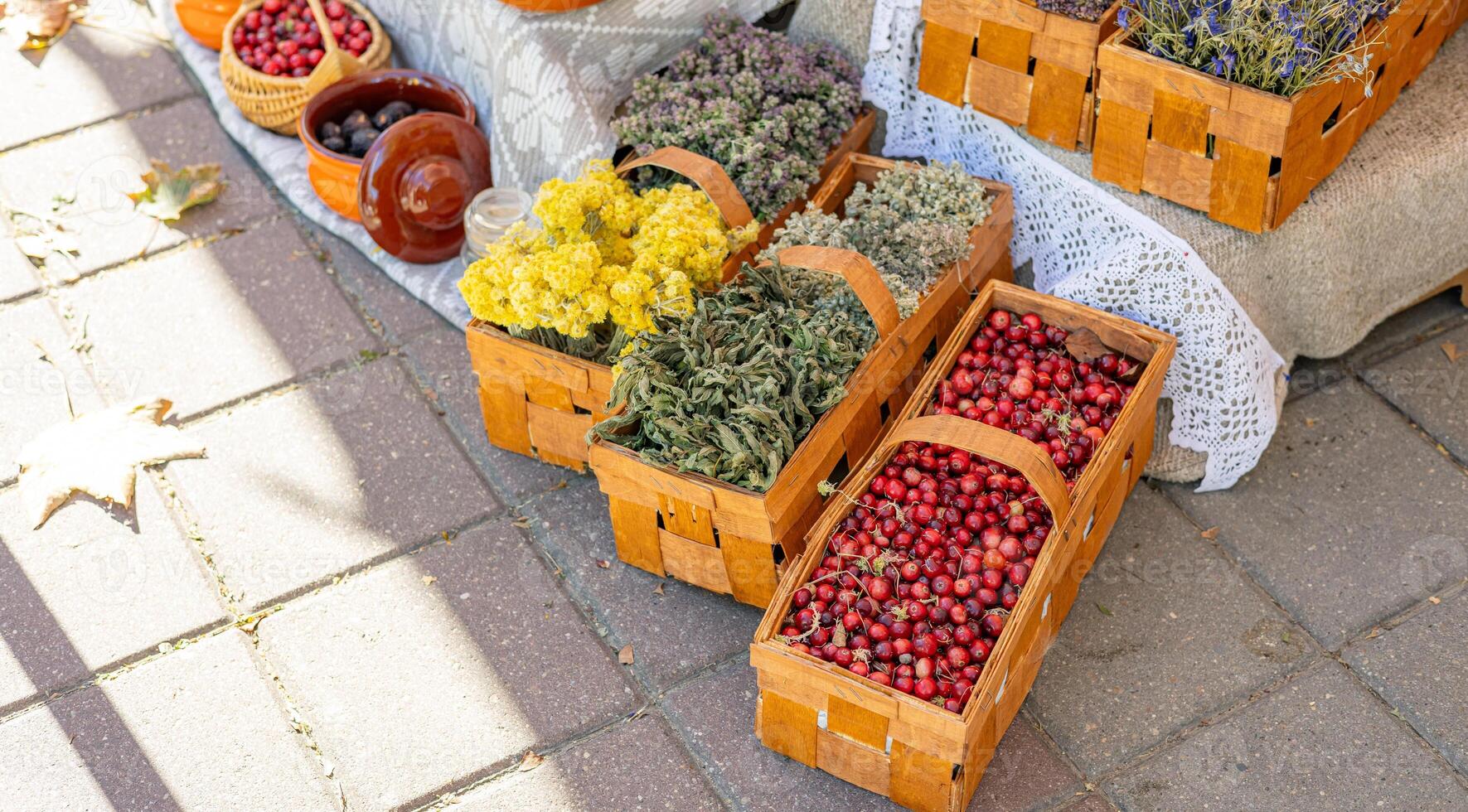 Market stall filled with fresh produce and dried herbs. The vibrant colors of the cranberries and the delicate hues of the dried herbs. Perfect for a blog post about local markets, a food magazine. photo