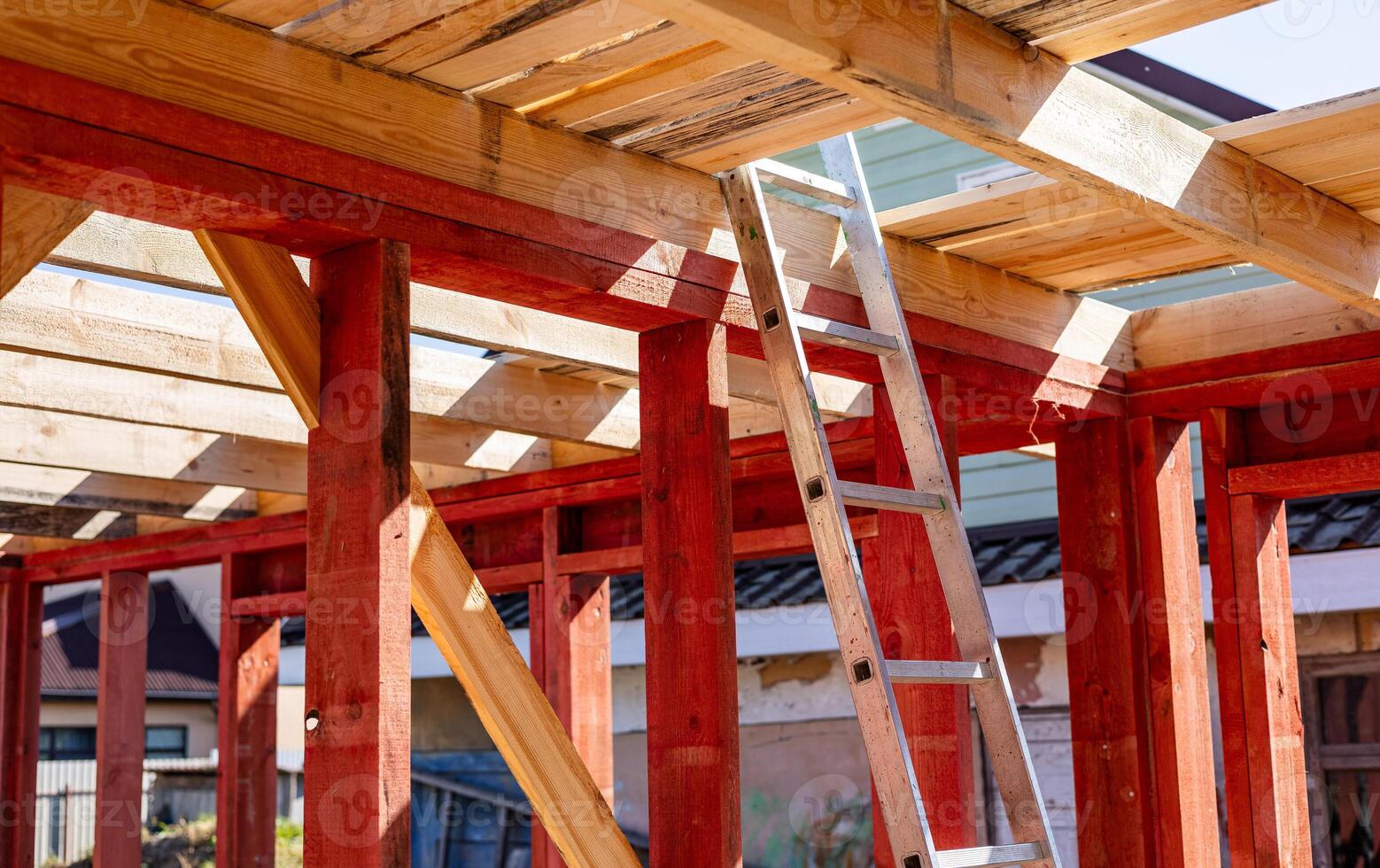 Under-construction residential wooden frame home located near a forest. Commencement of a new construction project for a cozy house or a mountain cottage. Idea of contemporary ecological construction. photo