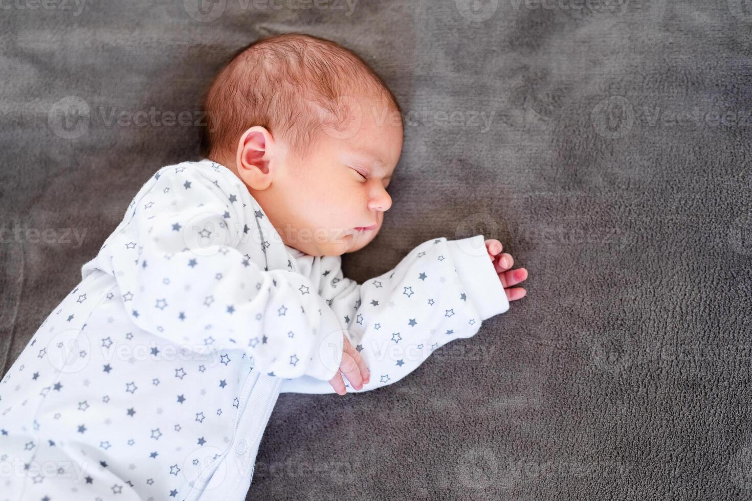 Close-up portrait of adorable baby boy sleeping in bed, 1 year old baby concept photo