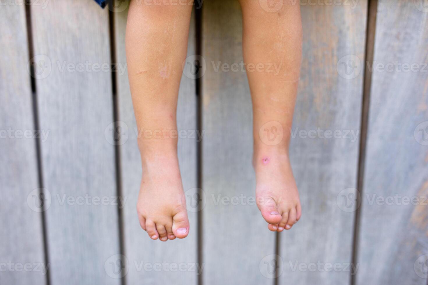 Small baby feet on the green grass. photo