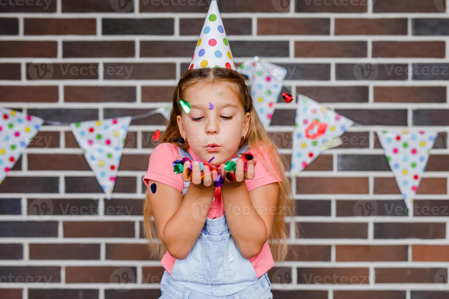 Cute preschooler girl makes art at a summer outdoor party photo