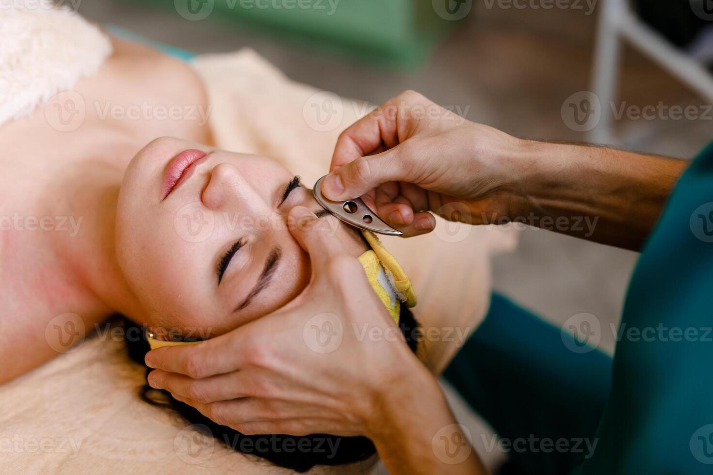 Facial massage with gouache stone in a beauty salon photo