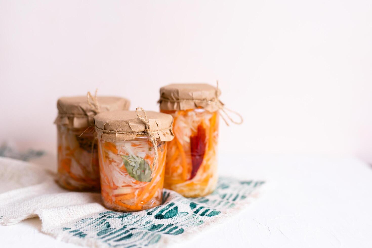 three jars of sauerkraut and carrots in its own juice. traditional home-made, fermented dish of Russia and Germany. photo