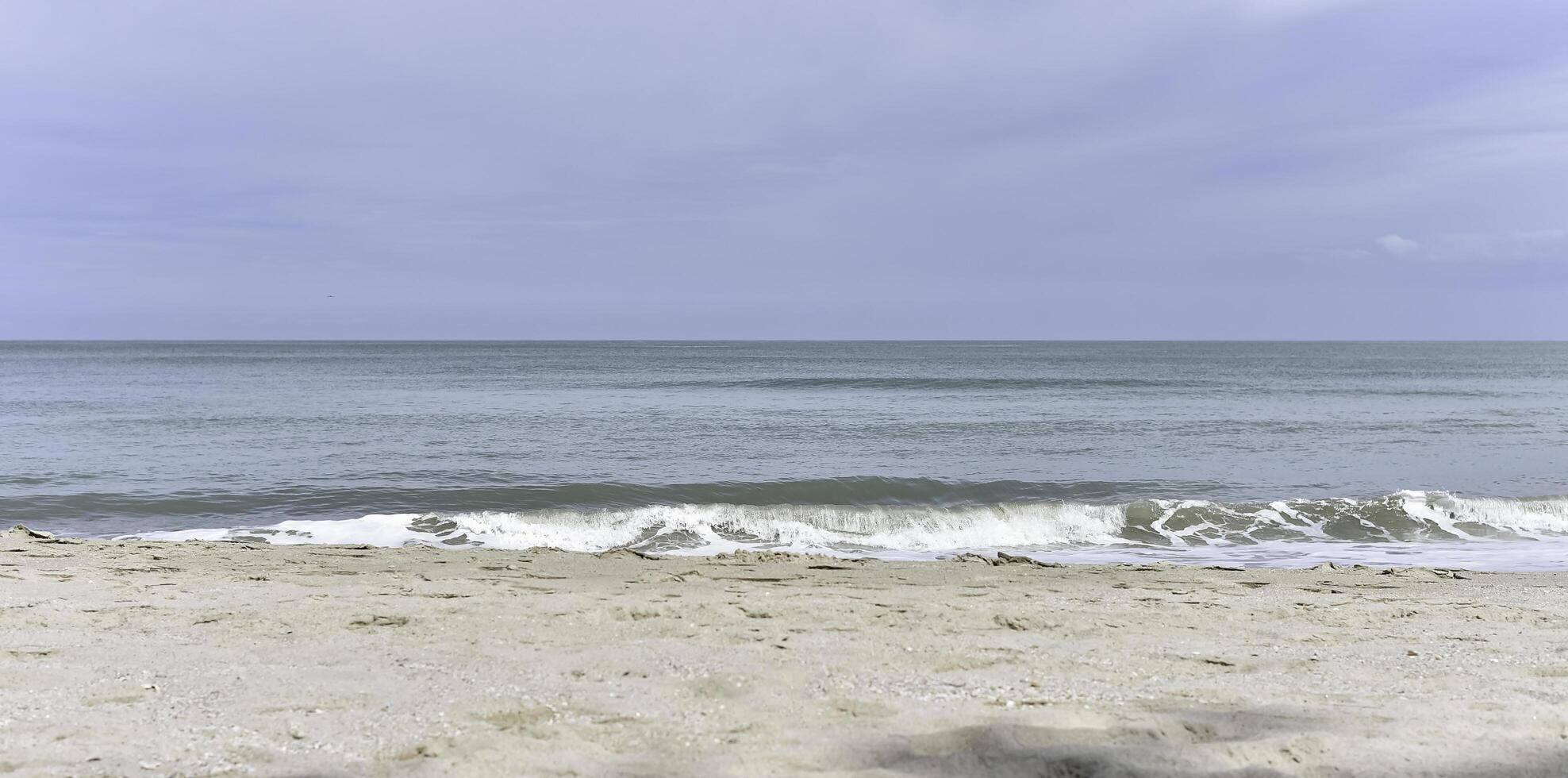 White soft Seawave surf on the beach, photo