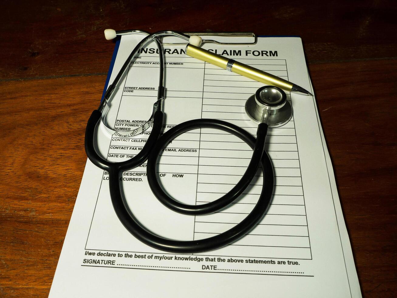 Stethoscope and pen put on insurance form photo