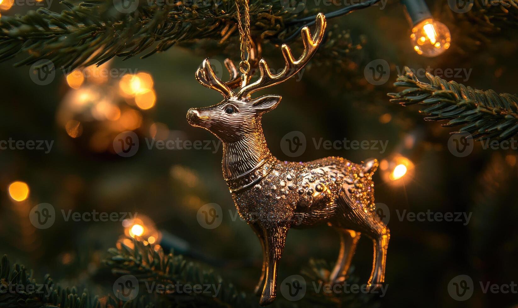 A gold deer ornament hangs on a Christmas tree photo