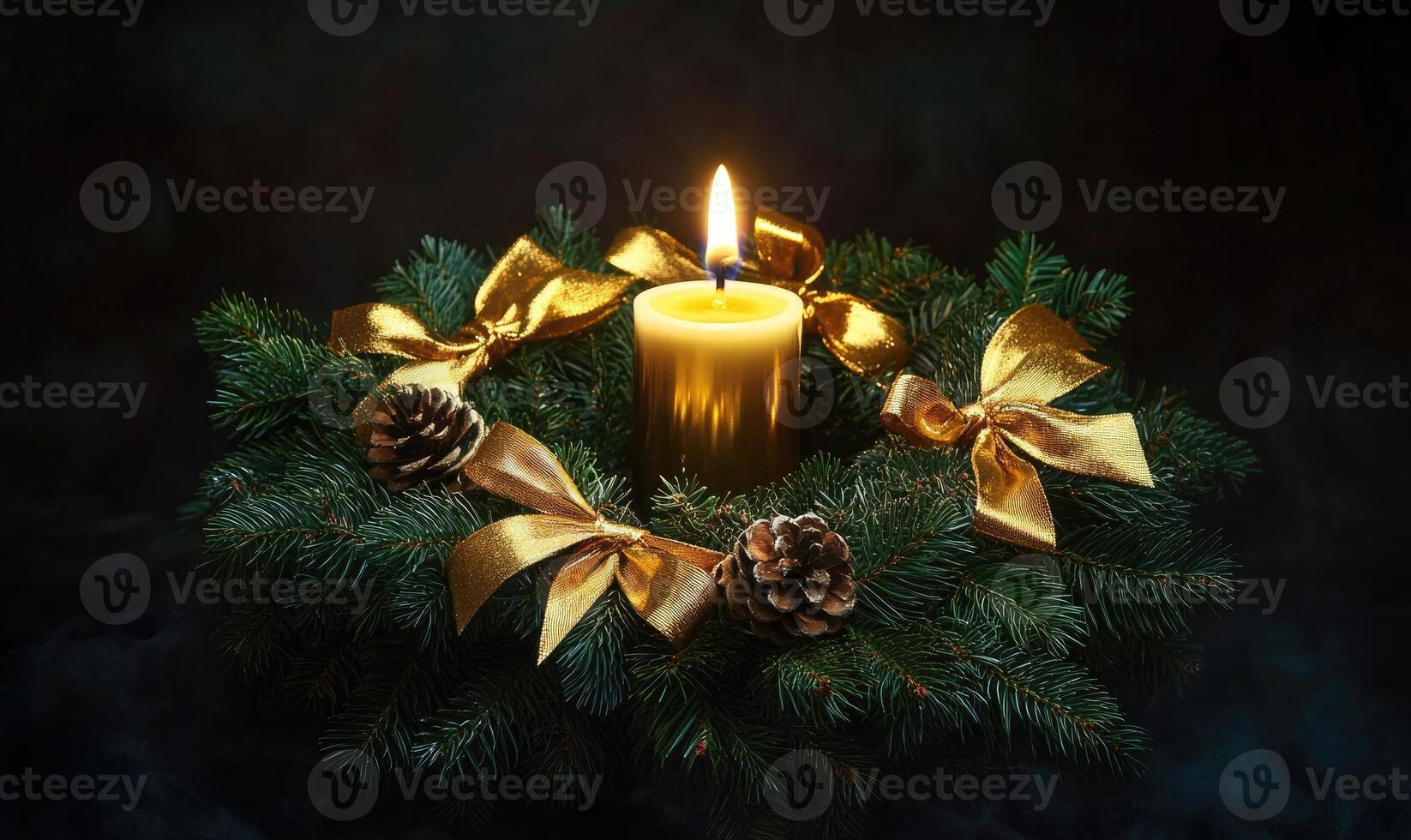 A candle is lit in a wreath of pine needles and gold ribbons photo