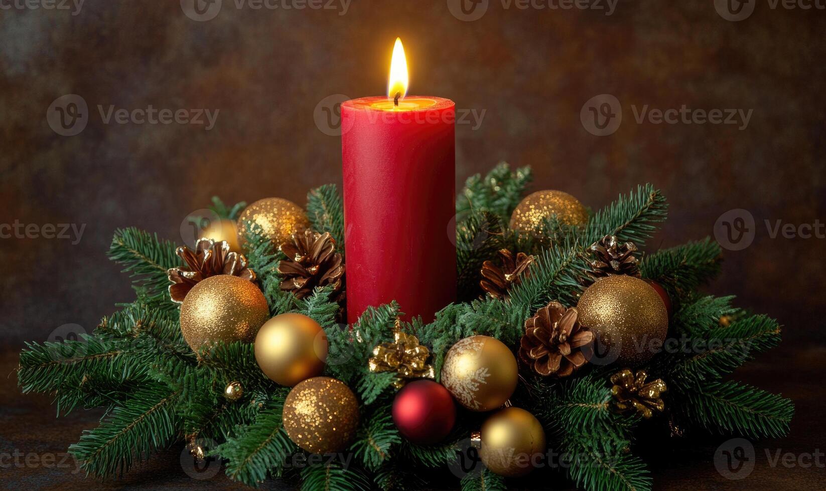 A red candle is lit on a Christmas wreath with gold and red decorations photo