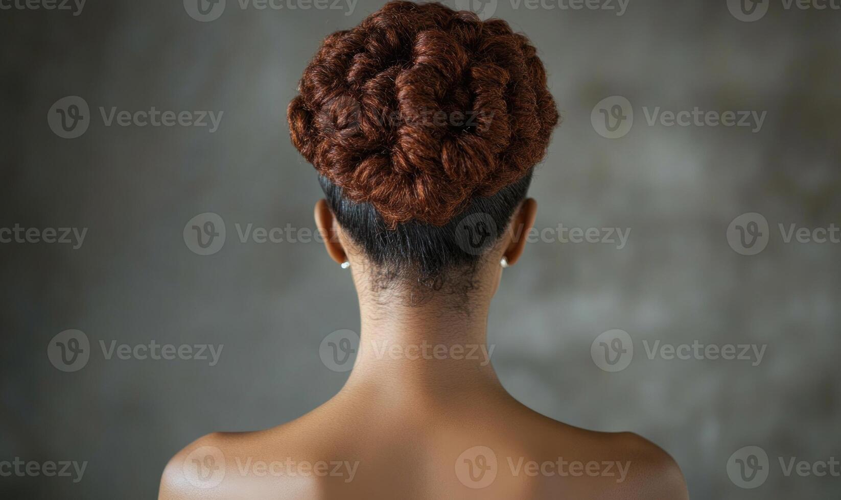 A woman with a red head has her hair in a bun photo