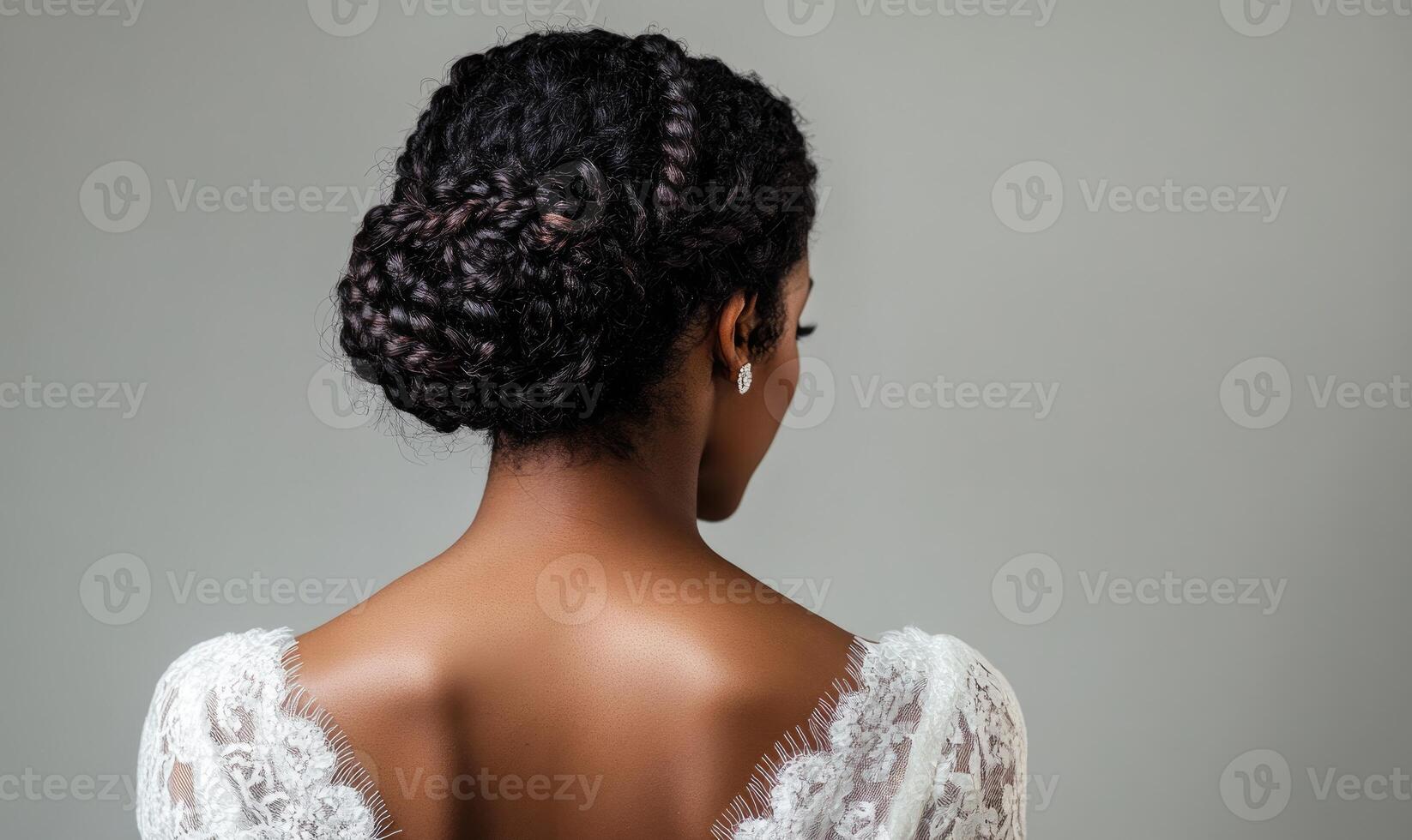 A woman with a braided hairstyle and a white dress photo