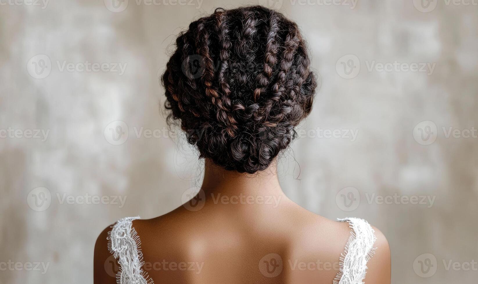 A woman with braided hair is wearing a white dress photo