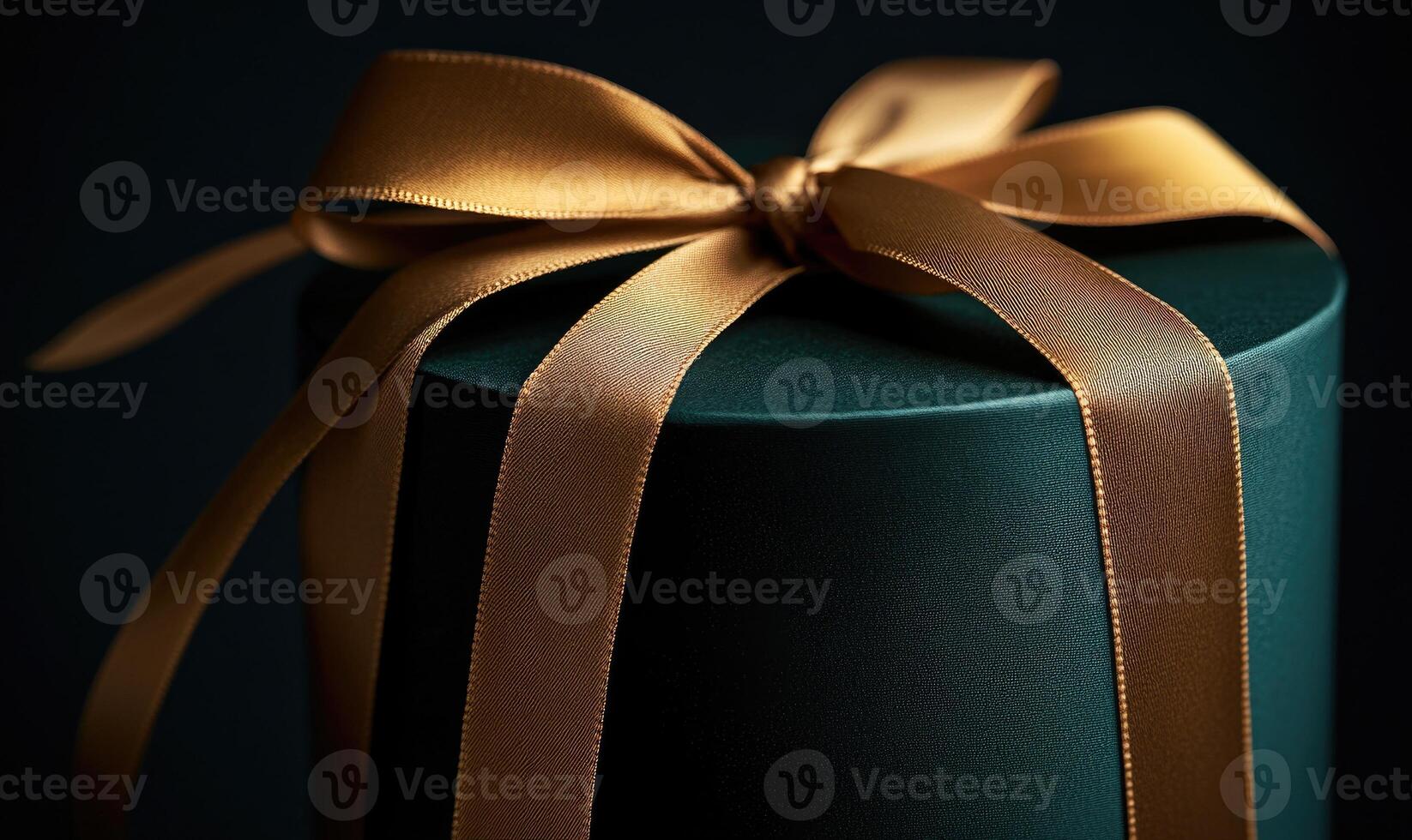 A green box with gold ribbons tied around it photo